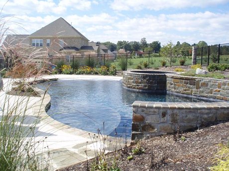 Custom built pool and landscaping by Mackie Brothers Pool